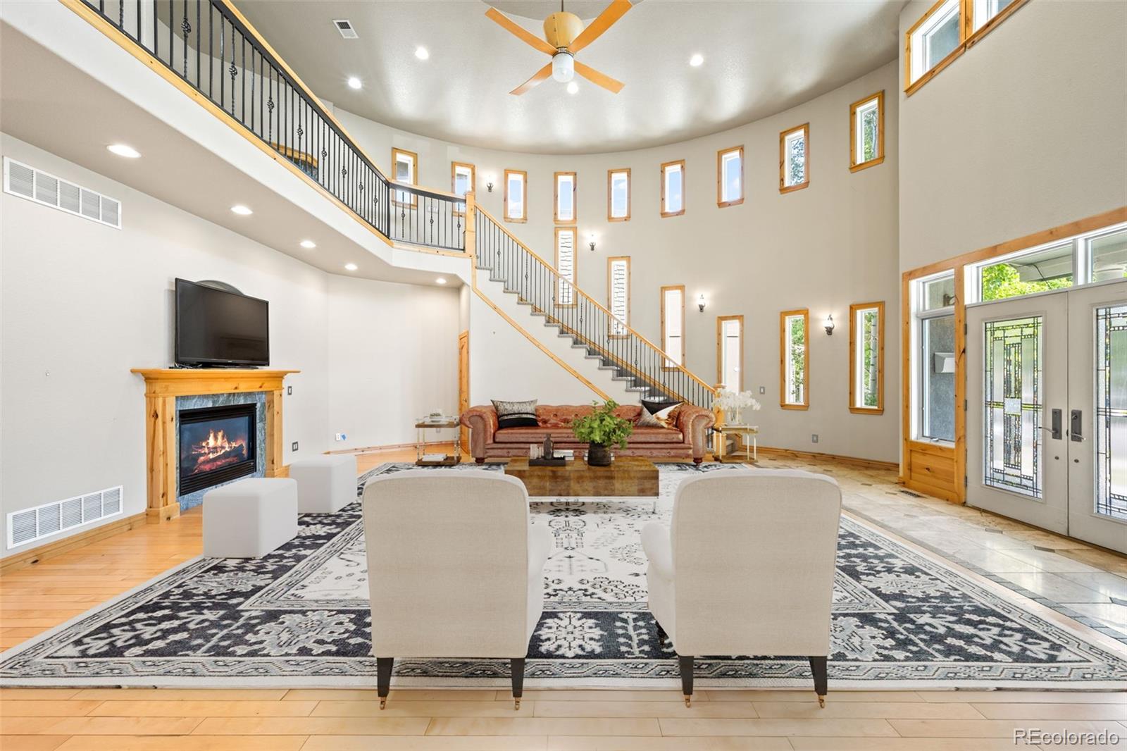 2895 South Cook Street Denver, CO 80210 - Photo 5 of 41 a living room with fireplace furniture and a rug