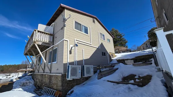a view of house with backyard