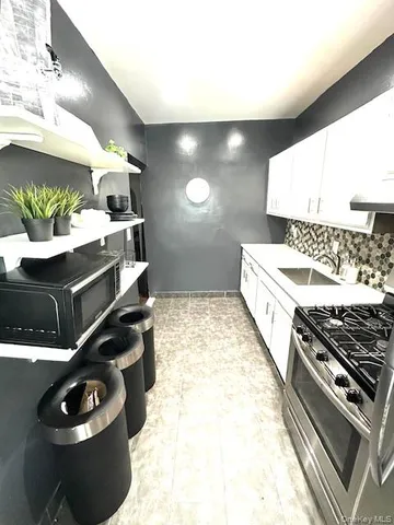a kitchen with stove and cabinets
