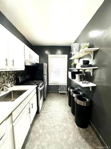 a kitchen with stainless steel appliances granite countertop a sink and a stove