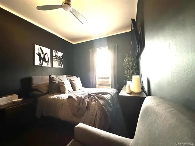 a bedroom with a bed window and couch