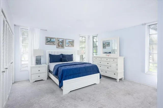 a spacious bedroom with a bed and a window