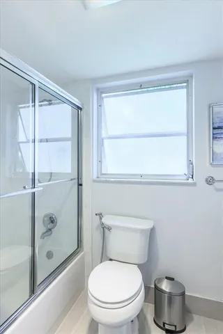 a bathroom with a toilet and a shower