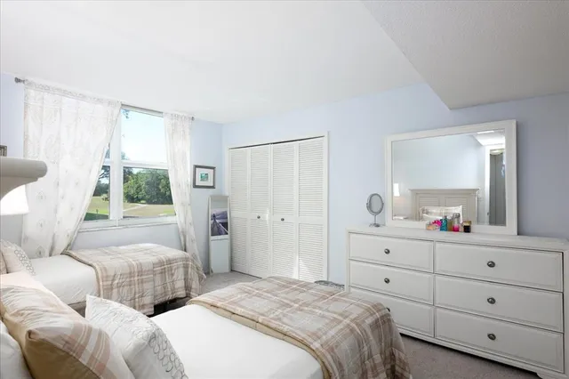 a bedroom with two beds and a window