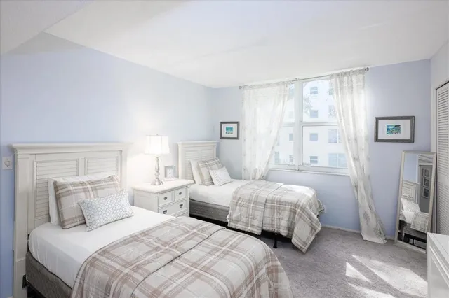 a bedroom with two beds and a window