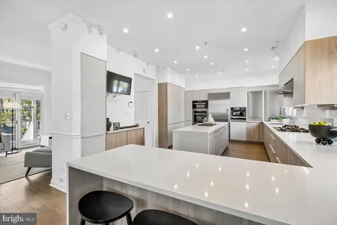 a kitchen with stainless steel appliances a refrigerator and a stove top oven
