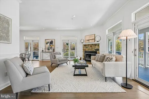 a living room with fireplace furniture and a wooden floor