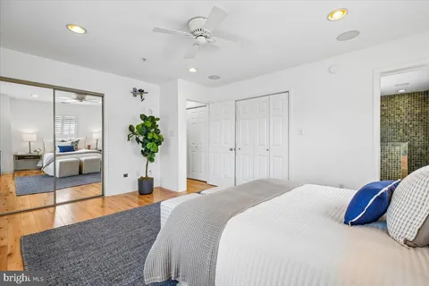 a spacious bedroom with a large bed and a chandelier