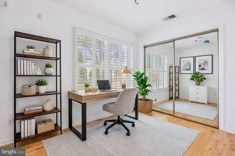 a view of a workspace with furniture and a potted plant