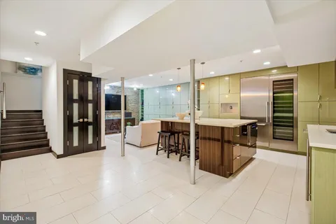 a lobby with furniture and a large mirror