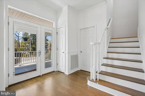 a view of an entryway with wooden floor and door