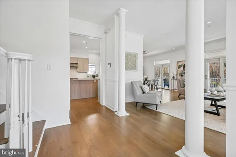 a view of living room with furniture and wooden floor