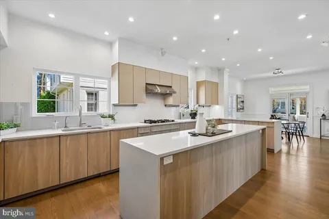 a large kitchen with stainless steel appliances a sink and a large island