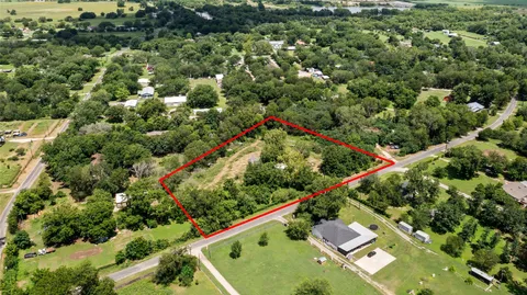 an aerial view of a residential houses with city view