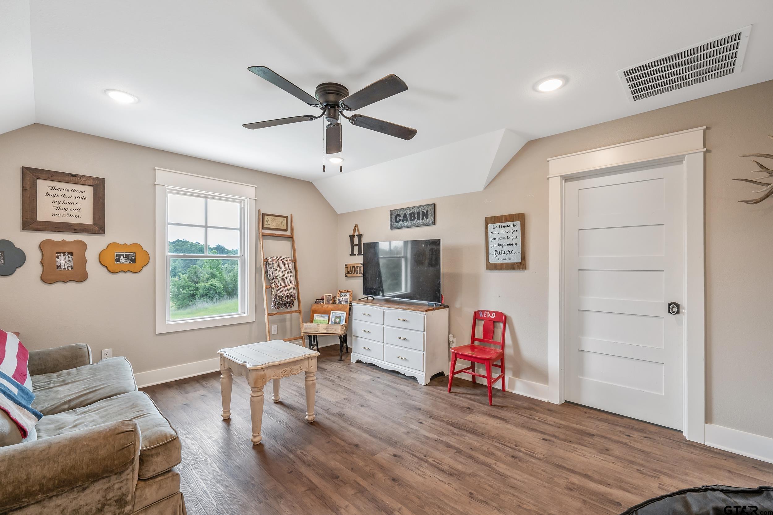 3022 County Road 3802 Bullard, TX 75757 - Photo 22 of 46 a living room with furniture and a flat screen tv