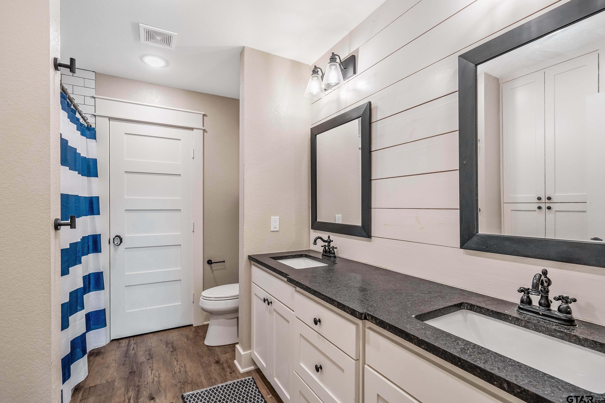3022 County Road 3802 Bullard, TX 75757 - Photo 25 of 46 a bathroom with a double vanity sink and a mirror
