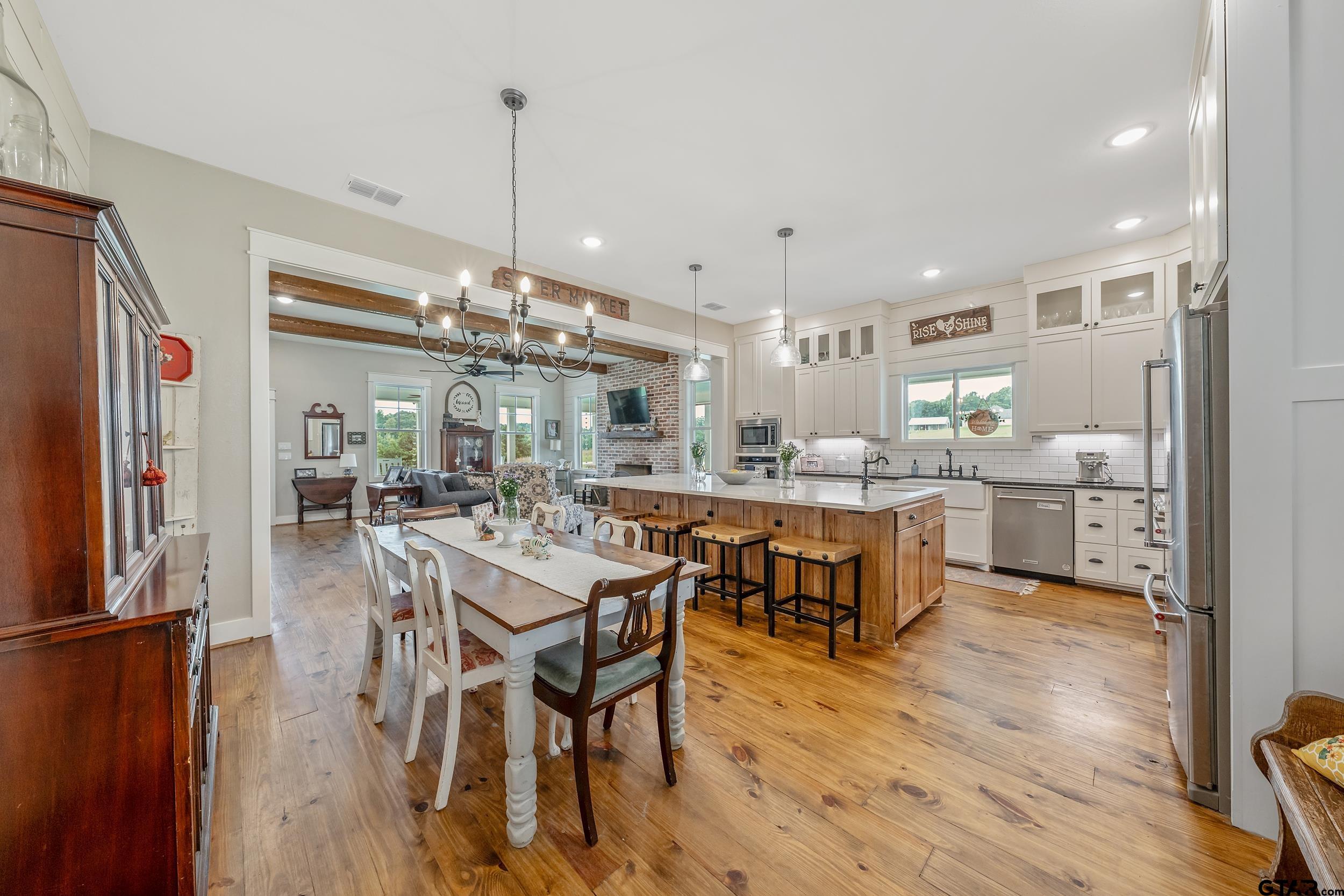 3022 County Road 3802 Bullard, TX 75757 - Photo 10 of 46 a dining area with stainless steel appliances kitchen island granite countertop a dining table chairs and granite counter tops