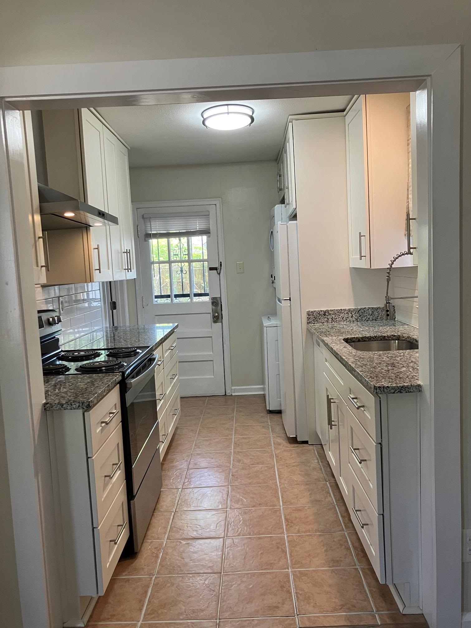 3827 Wilshire Road Memphis, TN 38111 - Photo 3 of 11 Pretty cabinets and granite counters. This kitchen is super functional - includes Dishwasher, Fridge, Range and Hood and stacked Washer/Dryer.