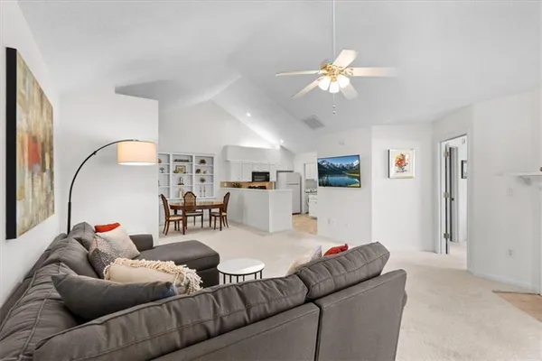 a living room with furniture and a chandelier