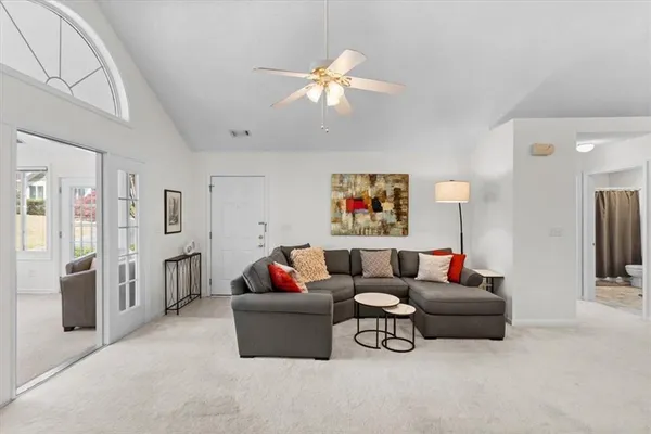 a living room with furniture and a chandelier