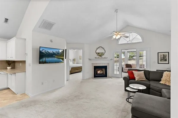 a living room with furniture a flat screen tv and a fireplace