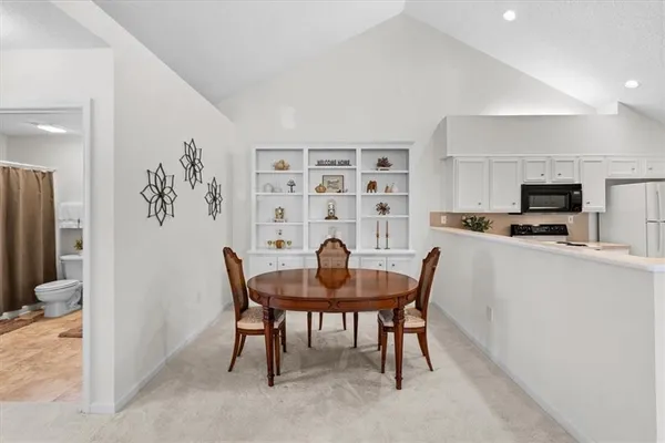 a workspace with furniture and a refrigerator