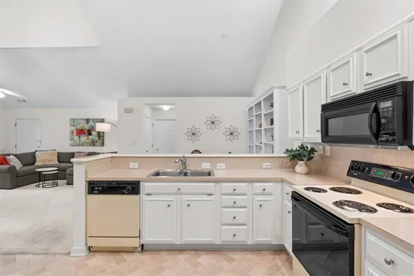 a kitchen with a sink stove and cabinets