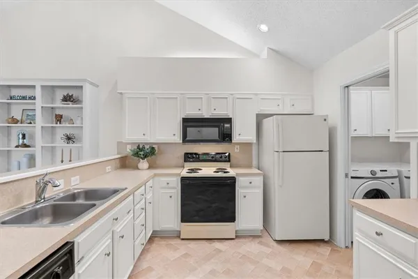 a kitchen with a sink white stove and refrigerator