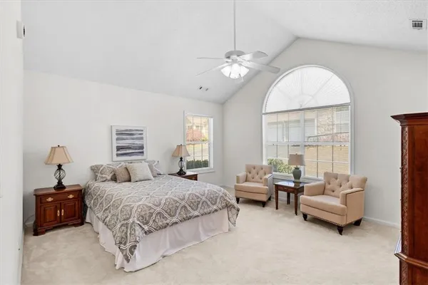 a bedroom with bed and a chandelier