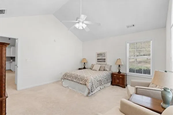 a spacious bedroom with a bed and a couch