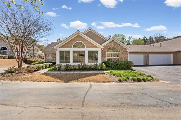 a front view of a house with a garden and pathway