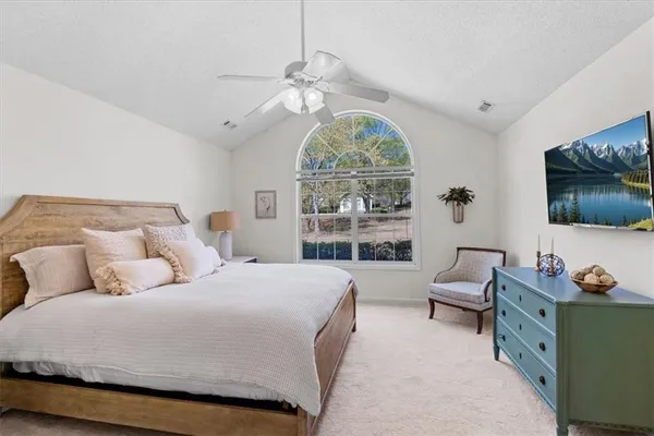 a bed room with a bed and a large window