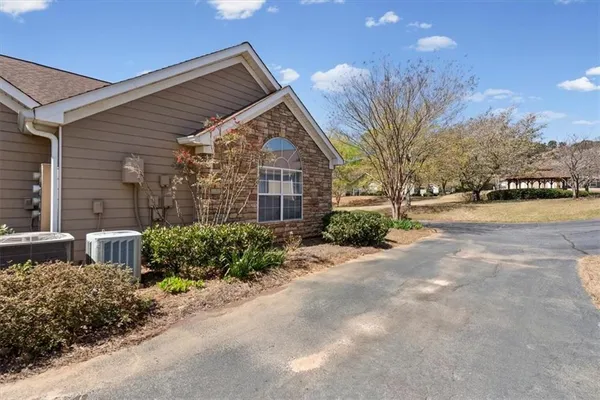 a view of a house with a yard and pathway