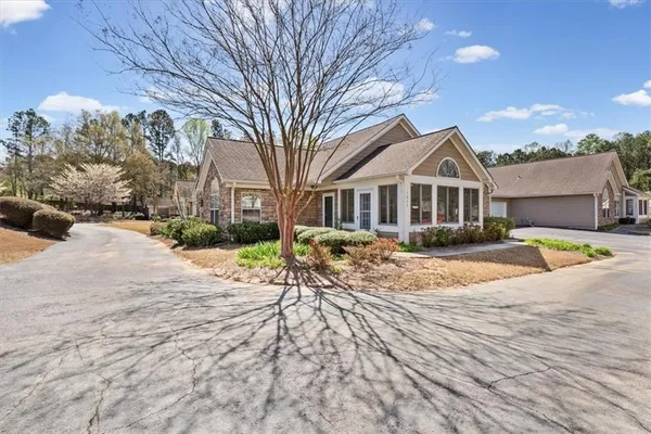 a view of a white house with a yard covered in snow