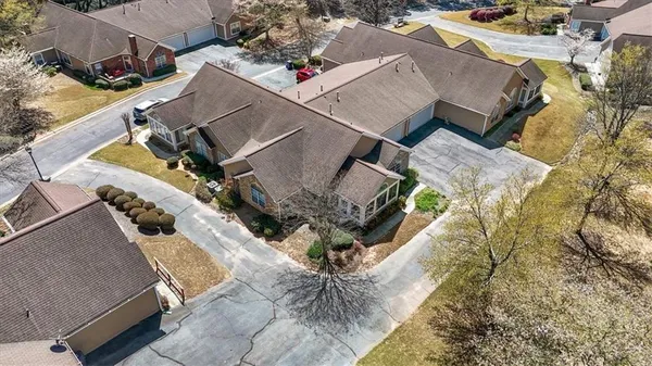 an aerial view of a house with a yard