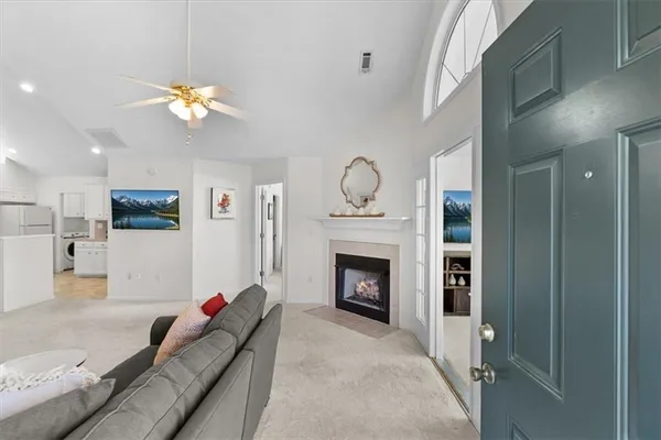 a living room with furniture a fireplace and a flat screen tv