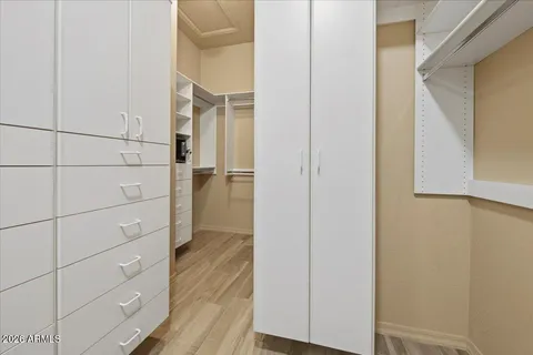 a spacious bathroom with a granite countertop sink and a mirror