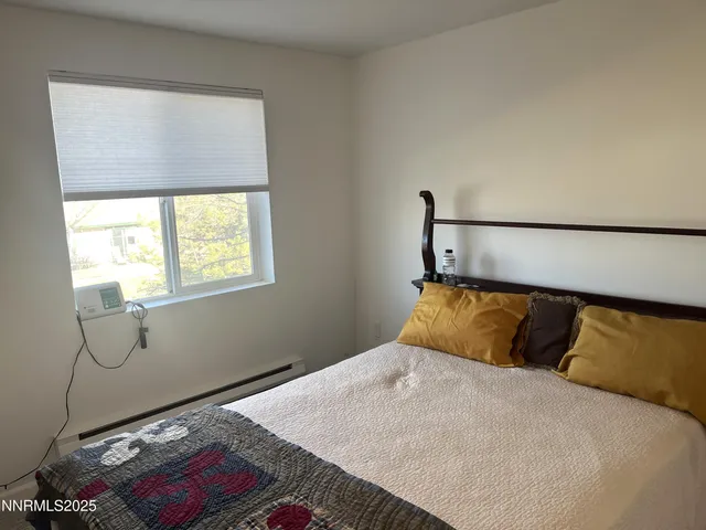 a bedroom with a bed and window