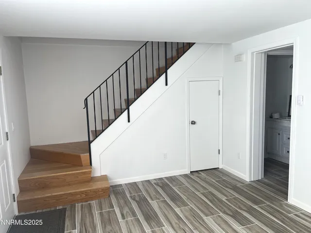 a view of entryway and hall with wooden floor