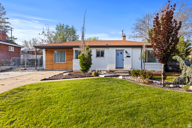 2101 West 3900th Street South Roy, UT 84067 - Photo 1 of 36 Exterior featuring white painted brick, natural wood paneling, a light blue front door, and a shingled roof