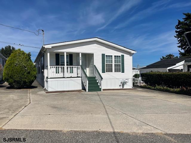 94 Center Drive Ocean View, NJ 08230 - Photo 1 of 12 a front view of a house with a yard