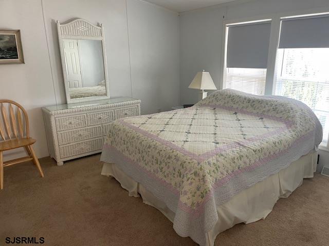 94 Center Drive Ocean View, NJ 08230 - Photo 7 of 12 a bedroom with a bed and a window