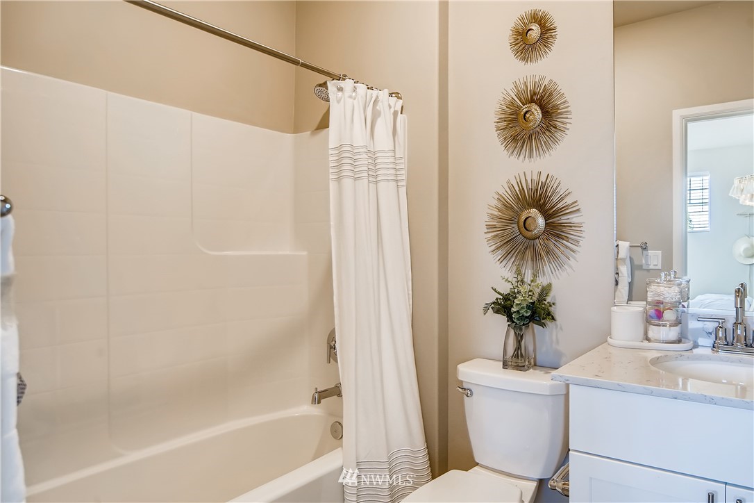 8812 Northeast 199th Street, Unit 1 Bothell, WA 98011 - Photo 13 of 31 a white bath tub sitting next to a white sink