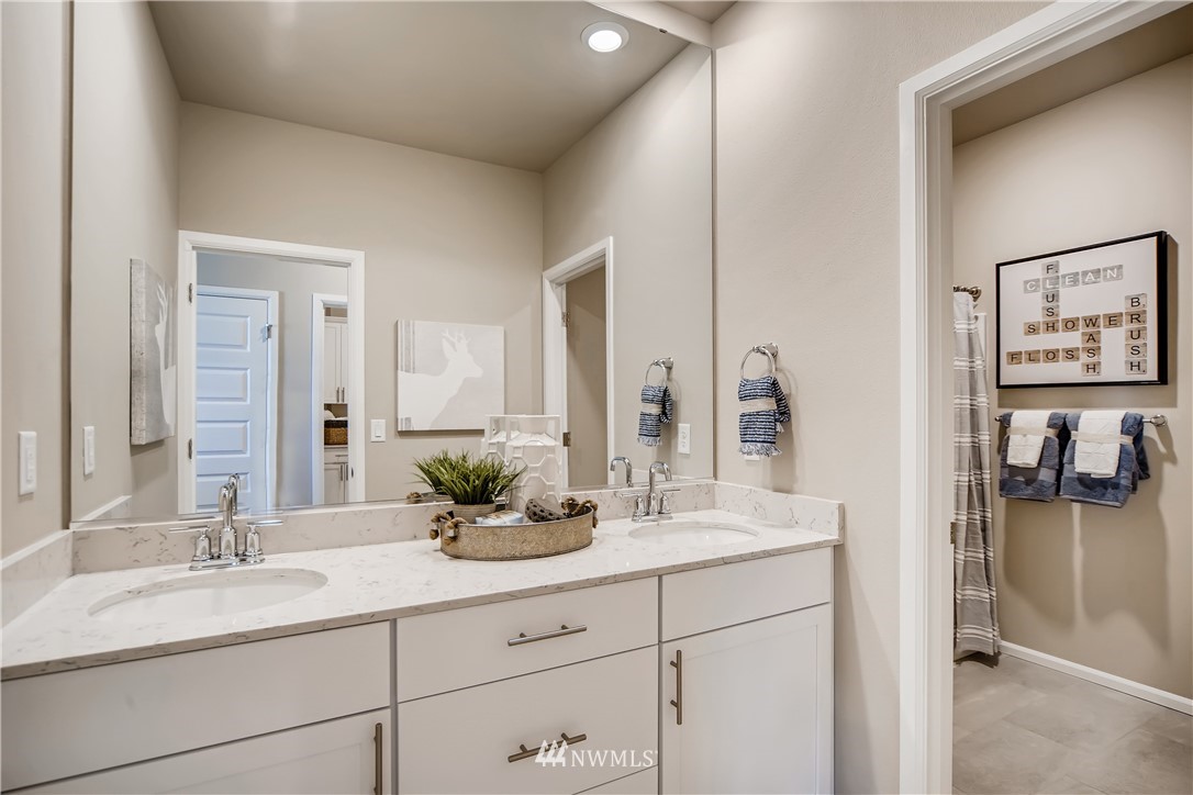 8812 Northeast 199th Street, Unit 1 Bothell, WA 98011 - Photo 14 of 31 a bathroom with a sink and a mirror