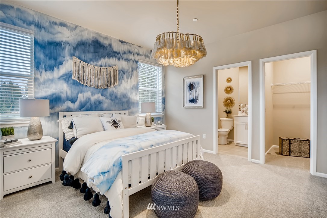 8812 Northeast 199th Street, Unit 1 Bothell, WA 98011 - Photo 15 of 31 a bedroom with bed and a chandelier