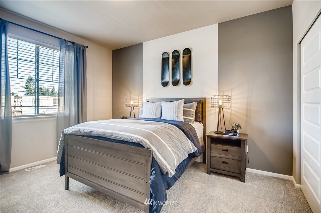 8812 Northeast 199th Street, Unit 1 Bothell, WA 98011 - Photo 17 of 31 a bedroom with a bed and two windows
