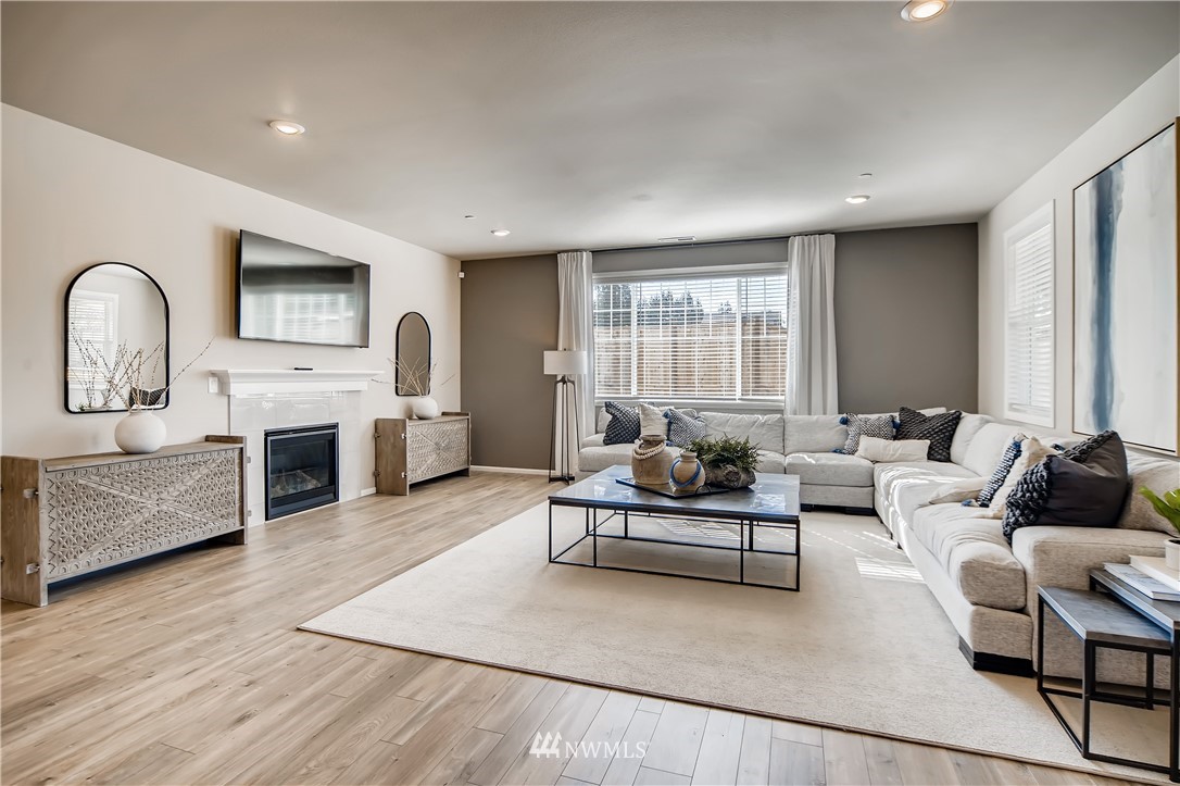 8812 Northeast 199th Street, Unit 1 Bothell, WA 98011 - Photo 23 of 31 a living room with furniture and a fireplace