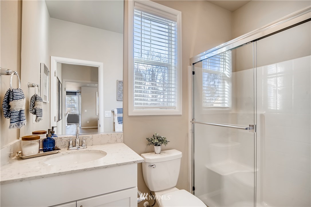 8812 Northeast 199th Street, Unit 1 Bothell, WA 98011 - Photo 26 of 31 a bathroom with a sink a toilet and shower