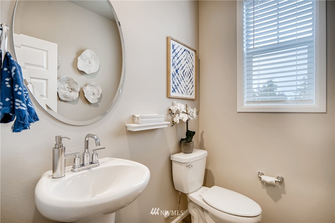 8812 Northeast 199th Street, Unit 1 Bothell, WA 98011 - Photo 29 of 31 a bathroom with a toilet sink and mirror