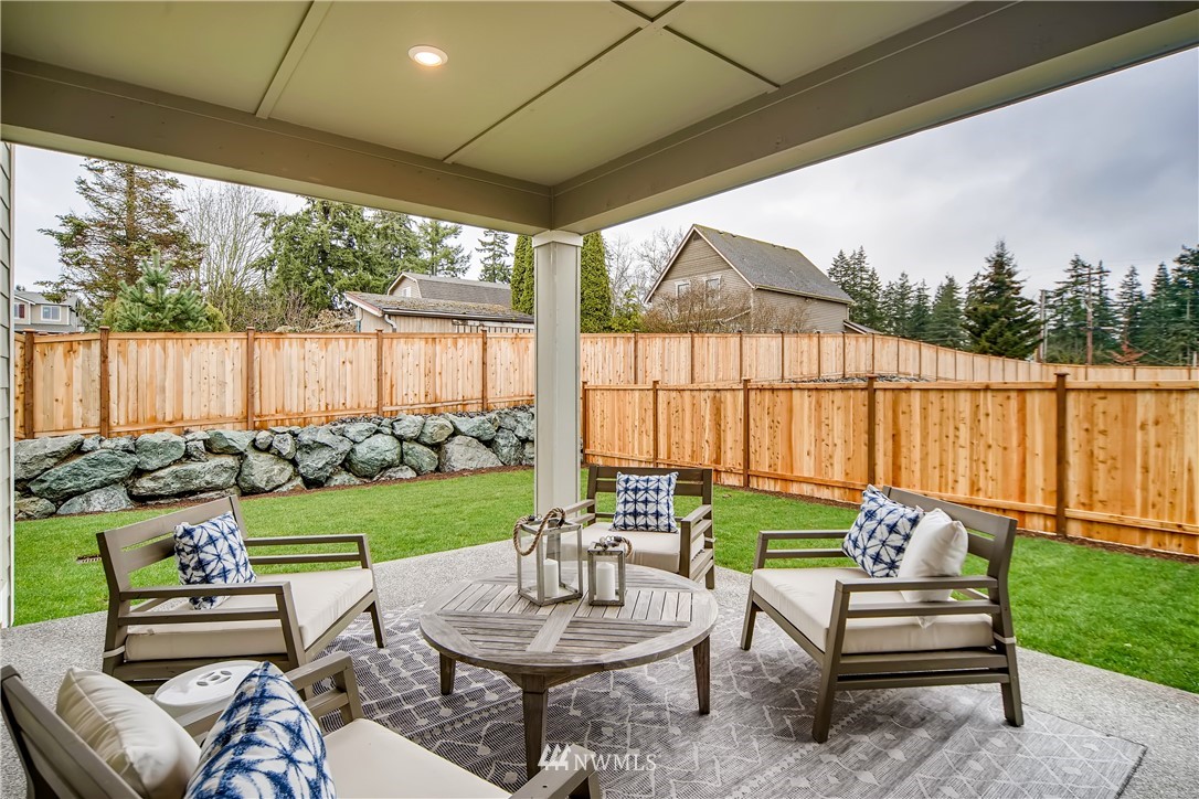 8812 Northeast 199th Street, Unit 1 Bothell, WA 98011 - Photo 30 of 31 a balcony with furniture and a garden